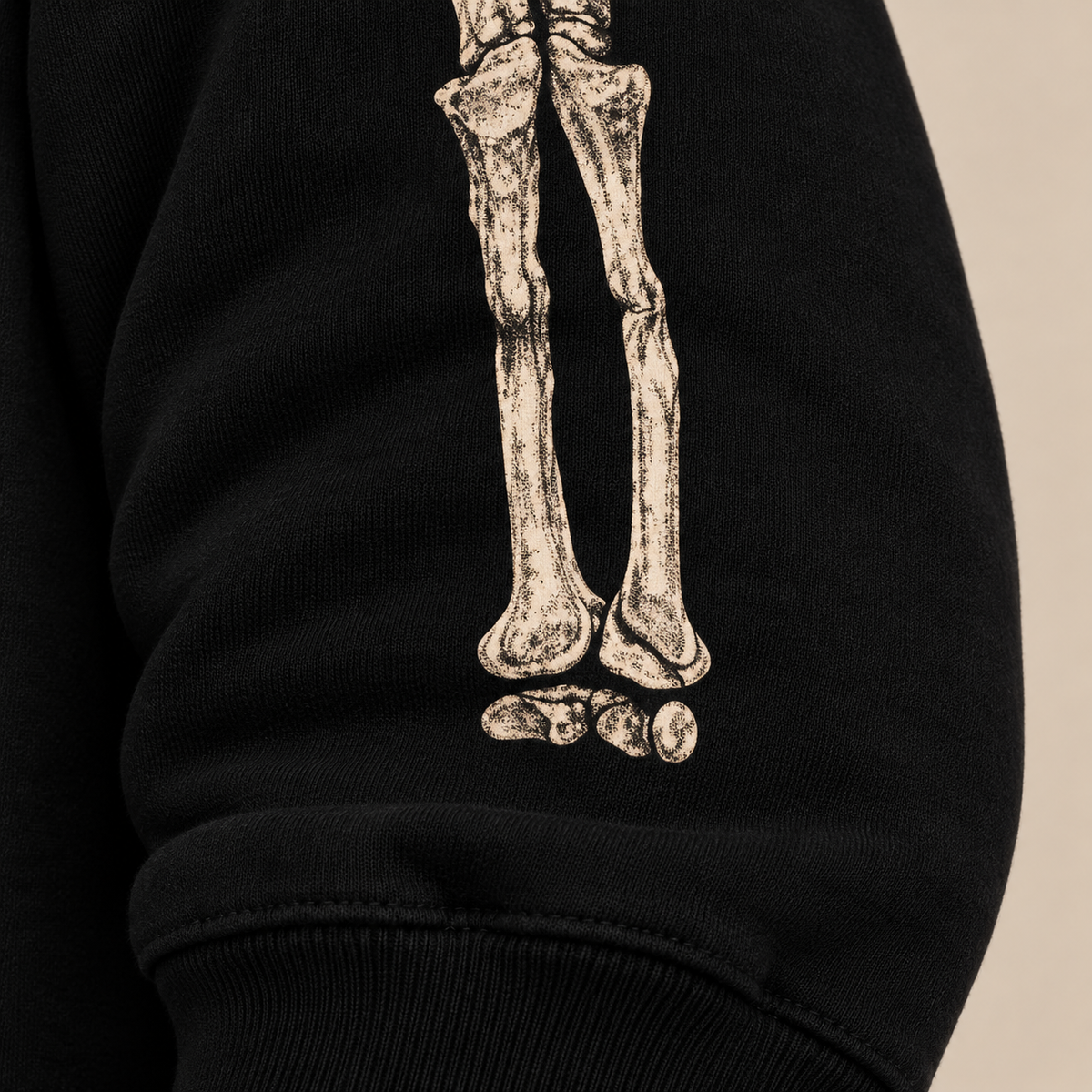 Anatomical bone sleeve graphic detail on BARE BONES black crewneck